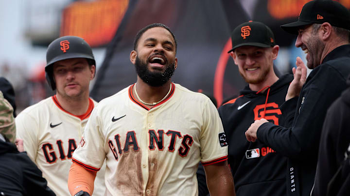 Apr 27, 2025; San Francisco, California, USA; San Francisco Giants outfielder Heliot Ramos (17) celebrates with his teammates after scoring the winning run against the Texas Rangers during the ninth inning at Oracle Park