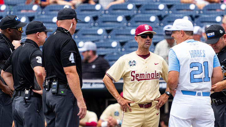 Jun 18, 2024; Omaha, NE, USA; Florida State Seminoles head coach Link Jarrett and North Carolina Tar Heels head coach Scott Forbes talk before the game at Charles Schwab Field Omaha. Mandatory Credit: Dylan Widger-Imagn Images