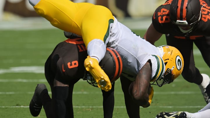 Cleveland Browns safety Grant Delpit (9) tackles Green Bay Packers running back Josh Jacobs (8) during the second quarter. Cleveland Browns safety Grant Delpit (9) tackles Green Bay Packers running back Josh Jacobs (8) during the second quarter.