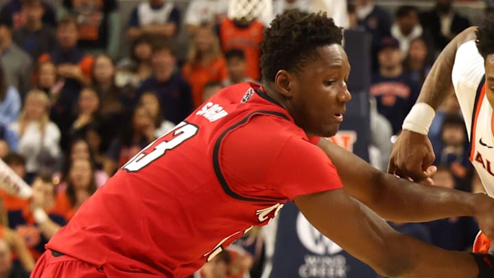 Dec 3, 2025; Auburn, Alabama, USA;  NC State Wolfpack forward Musa Sagnia (13) fouls Auburn Tigers guard Tahaad Pettiford (0) during the second half at Neville Arena. Mandatory Credit: John Reed-Imagn Images