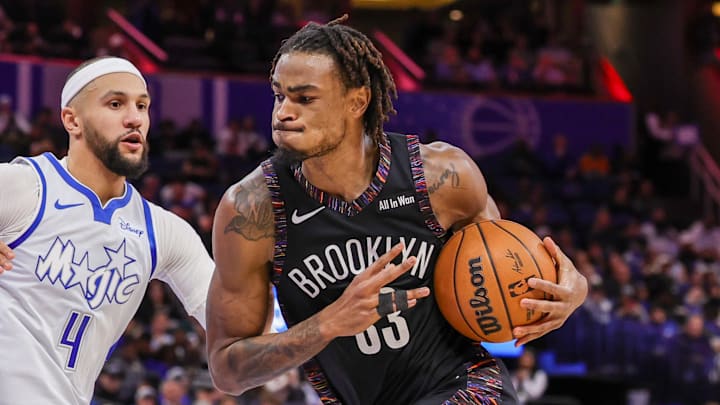 Feb 5, 2026; Orlando, Florida, USA; Brooklyn Nets center Nic Claxton (33) drives against Orlando Magic guard Jalen Suggs (4) during the second quarter at Kia Center. Mandatory Credit: Mike Watters-Imagn Images