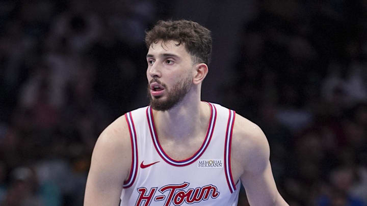 Feb 19, 2026; Charlotte, North Carolina, USA; Houston Rockets center Alperen Sengun (28) brings the ball up court against Charlotte Hornets forward Xavier Tillman (26) during the second half at Spectrum Center. Mandatory Credit: Jim Dedmon-Imagn Images