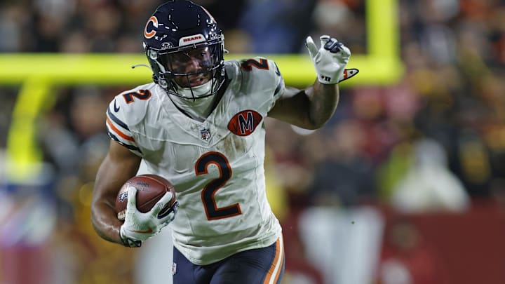 Oct 13, 2025; Landover, Maryland, USA; Chicago Bears wide receiver DJ Moore (2) escapes the tackle of Washington Commanders safety Jeremy Reaves (39) during the first quarter at Northwest Stadium.