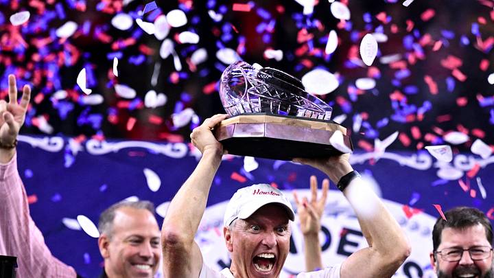 Dec 27, 2025; Houston, TX, USA; Houston Cougars head coach Willie Fritz hoists the champions trophy after the win over Louisiana State Tigers at NRG Stadium. Mandatory Credit: Maria Lysaker-Imagn Images Dec 27, 2025; Houston, TX, USA; Houston Cougars head coach Willie Fritz hoists the champions trophy after the win over Louisiana State Tigers at NRG Stadium. Mandatory Credit: Maria Lysaker-Imagn Images