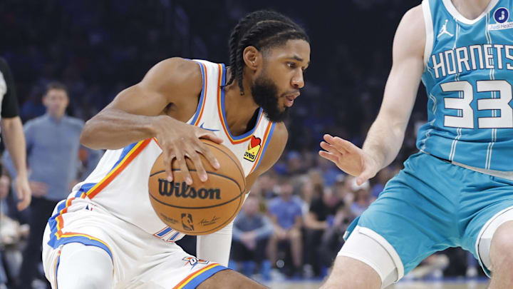 Oklahoma City Thunder guard Isaiah Joe (11) drives down the court beside Charlotte Hornets forward Liam McNeeley (33) during the second quarter of a game between the Charlotte Hornets and the Oklahoma City Thunder at Paycom Center.