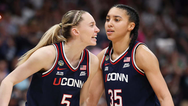 Apr 6, 2025; Tampa, FL, USA; Connecticut Huskies guard Paige Bueckers (5) reacts with teammates guard Ashlynn Shade (12) and guard Azzi Fudd (35) during the second half against the South Carolina Gamecocks of the national championship of the women's 2025 NCAA tournament at Amalie Arena. Mandatory Credit: Nathan Ray Seebeck-Imagn Images Apr 6, 2025; Tampa, FL, USA; Connecticut Huskies guard Paige Bueckers (5) reacts with teammates guard Ashlynn Shade (12) and guard Azzi Fudd (35) during the second half against the South Carolina Gamecocks of the national championship of the women's 2025 NCAA tournament at Amalie Arena. Mandatory Credit: Nathan Ray Seebeck-Imagn Images