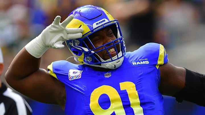Oct 6, 2024; Inglewood, California, USA; Los Angeles Rams defensive tackle Kobie Turner (91) reacts after sacking Green Bay Packers quarterback Jordan Love (10) during the first half at SoFi Stadium. Mandatory Credit: Gary A. Vasquez-Imagn Images