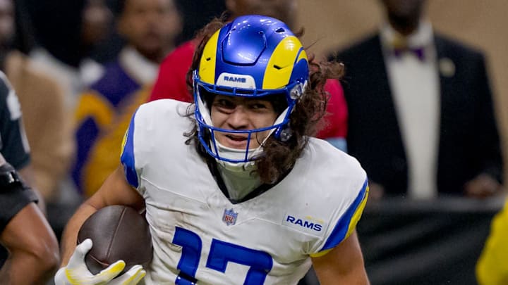 Dec 1, 2024; New Orleans, Louisiana, USA; Los Angeles Rams wide receiver Puka Nacua (17) scores a touchdown against New Orleans Saints linebacker Pete Werner (20) during the second half at Caesars Superdome. Mandatory Credit: Matthew Hinton-Imagn Images