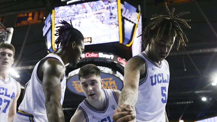 Mar 7, 2024; Los Angeles, California, USA; Members of the UCLA mens basketball team assist UCLA guard Sebastian Mack (12) during the second half of a game against the Arizona Wildcats at Pauley Pavilion presented by Wescom. Mandatory Credit: Yannick Peterhans-Imagn Images Mar 7, 2024; Los Angeles, California, USA; Members of the UCLA mens basketball team assist UCLA guard Sebastian Mack (12) during the second half of a game against the Arizona Wildcats at Pauley Pavilion presented by Wescom. Mandatory Credit: Yannick Peterhans-Imagn Images
