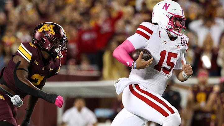 Nebraska quarterback Dylan Raiola runs the ball against Minnesota linebacker Emmanuel Karmo. Raiola has been sacked 25 times this season.