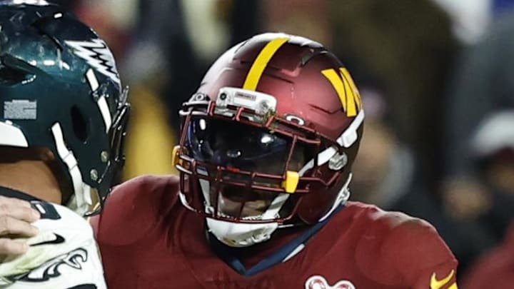 Washington Commanders linebacker Bobby Wagner argues with Philadelphia Eagles running back Saquon Barkley.