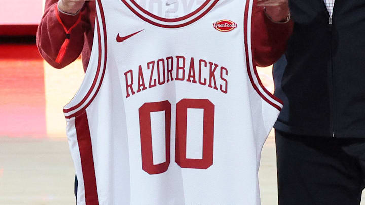 Mar 4, 2026; Fayetteville, Arkansas, USA; Tyson Foods chairman John Tyson is presented with a jersey at halftime from Arkansas Razorbacks athletics director Hunter Yurachek, while announcing a landmark athletic sponsorship in a multiyear deal that will place the Tyson Foods logo on the jerseys of all nineteen athletic teams at Arkansas. Arkansas won 105-85. Mandatory Credit: Nelson Chenault-Imagn Images