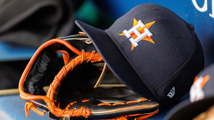 Apr 27, 2025; Kansas City, Missouri, USA; Houston Astros hat and glove in the dugout during the second inning against the Kansas City Royals at Kauffman Stadium. 