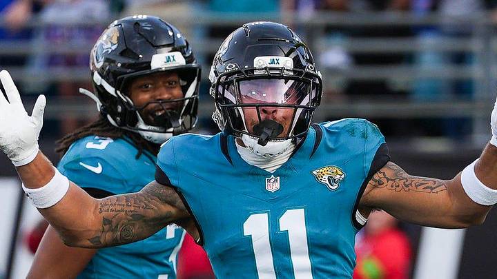 Jacksonville Jaguars wide receiver Parker Washington (11) celebrates his touchdown during the fourth quarter in an NFL football AFC Wild Card playoff matchup, Sunday, Jan. 11, 2026, in Jacksonville, Fla. Bills lead 10-7 at the half over the Jaguars. The Bills defeated the Jaguars 27-24. 