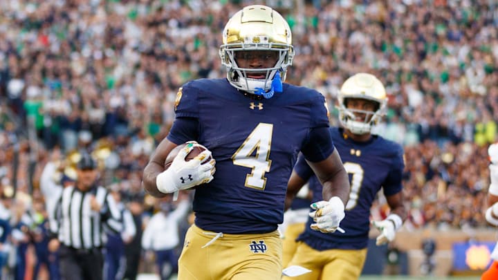 Notre Dame running back Jeremiyah Love (4) runs the ball into the end zone for a touchdown in the first half of a NCAA football game against Syracuse at Notre Dame Stadium on Saturday, Nov. 22, 2025, in South Bend. Notre Dame running back Jeremiyah Love (4) runs the ball into the end zone for a touchdown in the first half of a NCAA football game against Syracuse at Notre Dame Stadium on Saturday, Nov. 22, 2025, in South Bend.