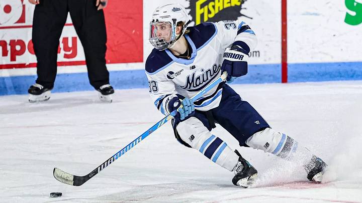 Maine Black Bear forward Oskar Komarov skates with the puck. Maine Black Bear forward Oskar Komarov skates with the puck.