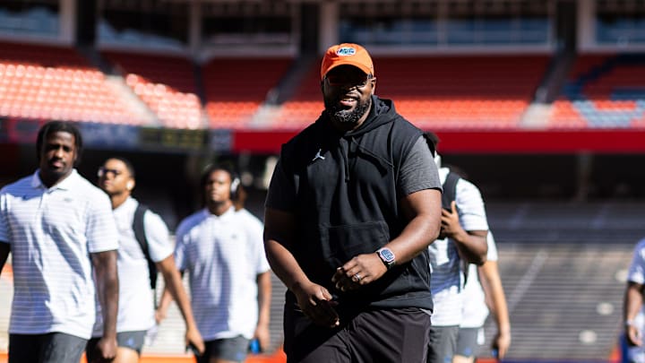 Florida Gators assistant coach for defensive line Gerald Chatman smiles with Florida Gators wide receiver Marcus Burke (88) during Gator Walk at the Orange and Blue spring football game at Steve Spurrier Field at Ben Hill Griffin Stadium in Gainesville, FL on Saturday, April 13, 2024. [Matt Pendleton/Gainesville Sun]