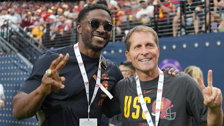 \ Southern California Trojans running back Reggie Bush (left) and basketball coach Eric Musselman pose during the game against the LSU Tigers at Allegiant Stadium. 