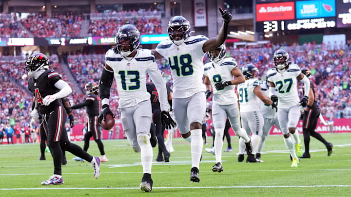 Dec 8, 2024; Glendale, Arizona, USA; Seattle Seahawks linebacker Ernest Jones IV (13) celebrates an interception against the Arizona Cardinals during the first half at State Farm Stadium.