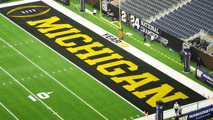 The Michigan Wolverines logo in the end zone before the 2024 College Football Playoff national championship The Michigan Wolverines logo in the end zone before the 2024 College Football Playoff national championship