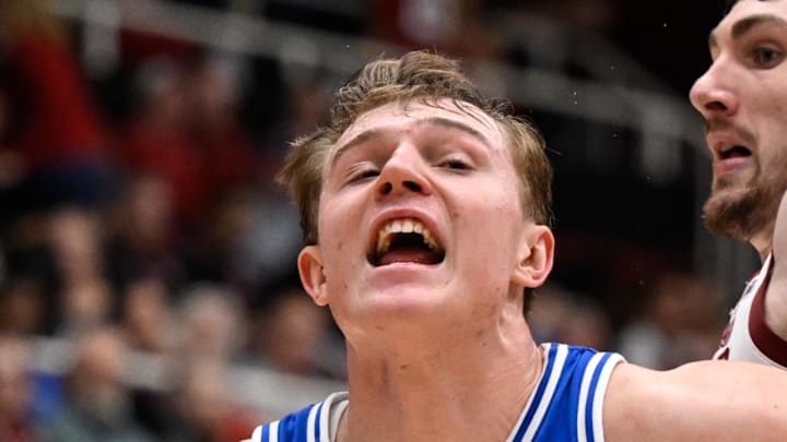 Jan 17, 2026; Stanford, California, USA; Duke Blue Devils guard Nikolas Khamenia (14) drives to the basket against Stanford Cardinal forward AJ Rohosy (4) in the second half at Maples Pavilion. Mandatory Credit: Eakin Howard-Imagn Images