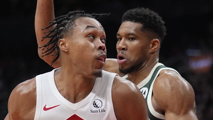 Toronto Raptors guard Scottie Barnes controls the ball against Milwaukee Bucks forward Giannis Antetokounmpo. Toronto Raptors guard Scottie Barnes controls the ball against Milwaukee Bucks forward Giannis Antetokounmpo.