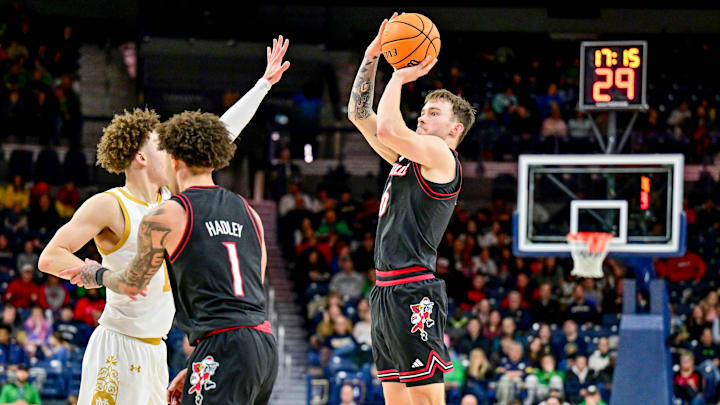 Feb 16, 2025; South Bend, Indiana, USA; Louisville Cardinals guard Reyne Smith (6) shoots a three point basket over Notre Dame Fighting Irish guard Braeden Shrewsberry (11) in the second half at the Purcell Pavilion. 