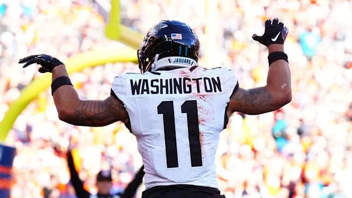 Dec 21, 2025; Denver, Colorado, USA; Jacksonville Jaguars wide receiver Parker Washington (11) reacts after making a touchdown catch against the Denver Broncos during the first half at Empower Field at Mile High. Mandatory Credit: Ron Chenoy-Imagn Images