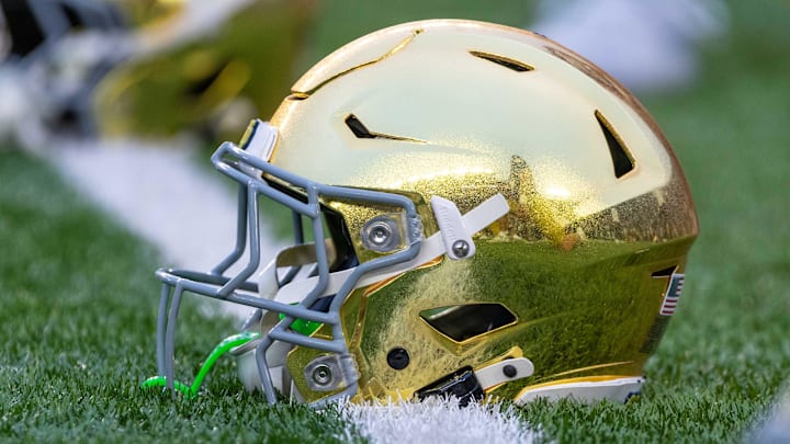 Sep 13, 2025; South Bend, Indiana, USA; A gold Notre Dame Fighting Irish helmet on the field before a game against the Texas A&M Aggies at Notre Dame Stadium. 
