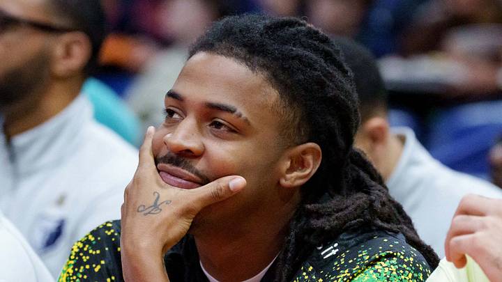 Nov 26, 2025; New Orleans, Louisiana, USA;  Memphis Grizzlies guard Ja Morant (left) watches a game against the New Orleans Pelicans at Smoothie King Center. Mandatory Credit: Matthew Hinton-Imagn Images