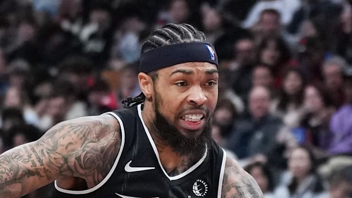 Toronto Raptors forward Brandon Ingram controls the ball as Atlanta Hawks forward Jalen Johnson tries to defend.