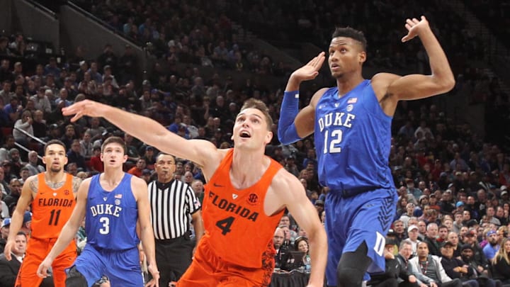 Nov 26, 2017; Portland, OR, USA; Florida Gators guard Egor Koulechov (4) watches the ball go into the net against Duke Blue Devils forward Javin DeLaurier (12) in the first half at Moda Center. Mandatory Credit: Jaime Valdez-Imagn Images Nov 26, 2017; Portland, OR, USA; Florida Gators guard Egor Koulechov (4) watches the ball go into the net against Duke Blue Devils forward Javin DeLaurier (12) in the first half at Moda Center. Mandatory Credit: Jaime Valdez-Imagn Images