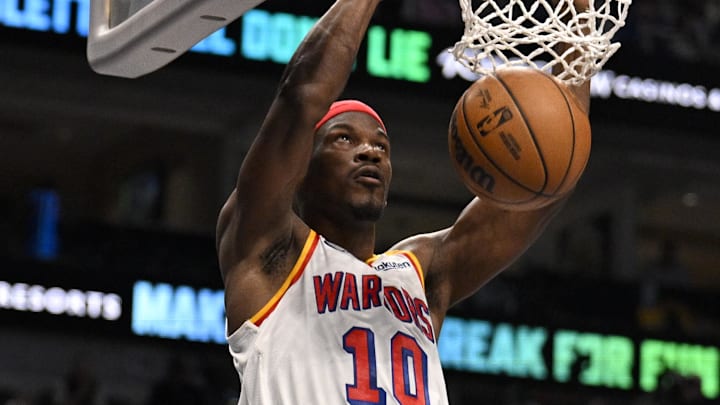 Feb 12, 2025; Dallas, Texas, USA; Golden State Warriors forward Jimmy Butler (10) dunks the ball against the Dallas Mavericks during the second quarter at the American Airlines Center. Mandatory Credit: Jerome Miron-Imagn Images