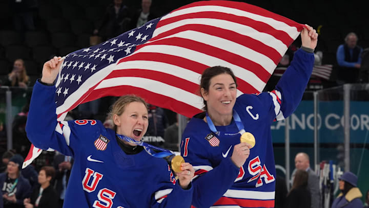 Feb 19, 2026; Milan, Italy; Kendall Coyne (26) of the United States and Hilary Knight (21) of the United States celebrate after winning the gold medal in women's ice hockey after defeating Canada during the Milano Cortina 2026 Olympic Winter Games at Milano Santagiulia Ice Hockey Arena. Mandatory Credit: Amber Searls-Imagn Images