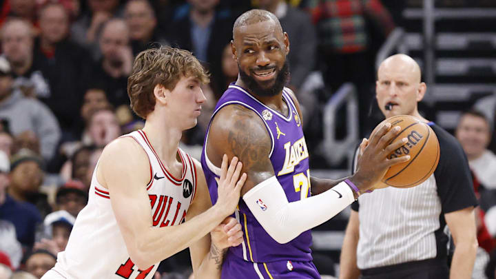 Jan 26, 2026; Chicago, Illinois, USA; Chicago Bulls forward Matas Buzelis (14) defends against Los Angeles Lakers forward LeBron James (23) during the first half at United Center. Mandatory Credit: Kamil Krzaczynski-Imagn Images
