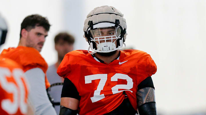 Isaia Glass (72) runs drills during an Oklahoma State football practice in Stillwater, Okla., on Tuesday, April 23, 2024.