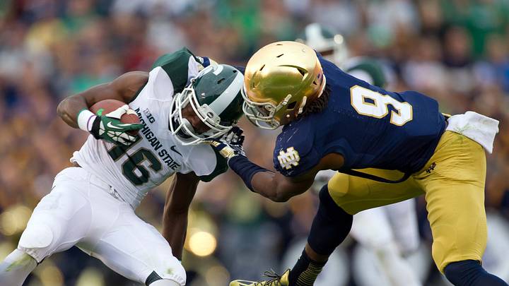 Sep 21, 2013; South Bend, IN, USA; Notre Dame Fighting Irish cornerback KeiVarae Russell (6) and linebacker Jaylon Smith (9) tackle Michigan State Spartans wide receiver Aaron Burbridge (16) in the fourth quarter at Notre Dame Stadium. Notre Dame won 17-13. Sep 21, 2013; South Bend, IN, USA; Notre Dame Fighting Irish cornerback KeiVarae Russell (6) and linebacker Jaylon Smith (9) tackle Michigan State Spartans wide receiver Aaron Burbridge (16) in the fourth quarter at Notre Dame Stadium. Notre Dame won 17-13.