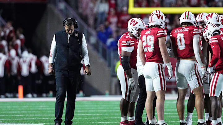 Oct 11, 2025; Madison, Wisconsin, USA; Wisconsin Badgers head coach Luke Fickell and his team take a timeout in the second half against the Iowa Hawkeyes at Camp Randall Stadium. Mandatory Credit: Ross Harried-Imagn Images