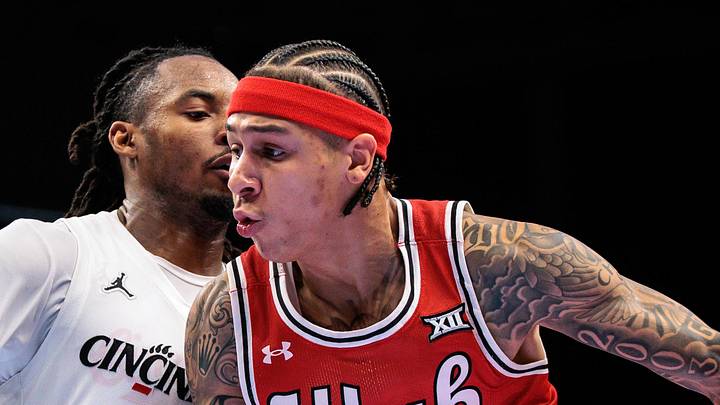 Mar 10, 2026; Kansas City, MO, USA; Utah Utes guard Terrence Brown (2) drives around Cincinnati Bearcats guard Day Day Thomas (1) during the second half at T-Mobile Center. Mandatory Credit: William Purnell-Imagn Images