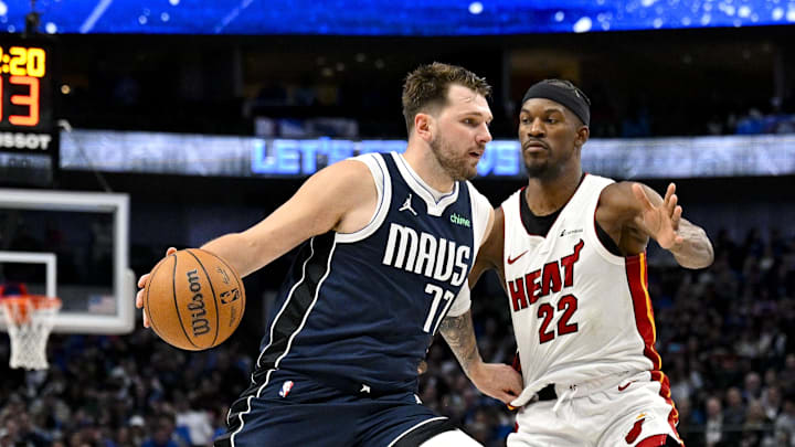 Mar 7, 2024; Dallas, Texas, USA; Dallas Mavericks guard Luka Doncic (77) looks the ball past Miami Heat forward Jimmy Butler (22) during the second half at the American Airlines Center. Mandatory Credit: Jerome Miron-Imagn Images