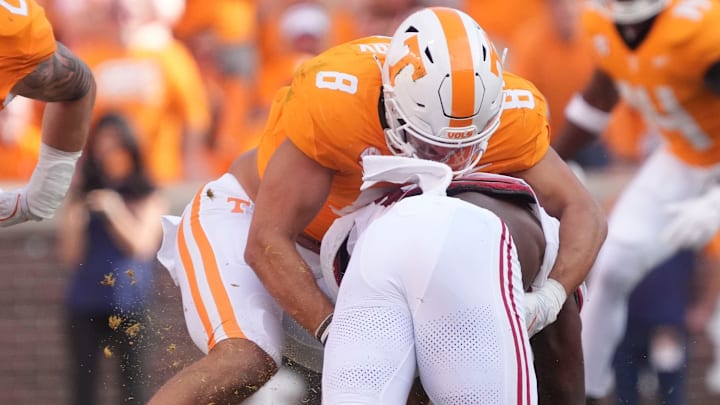 Tennessee linebacker Kalib Perry (8) tackles Alabama running back Jam Miller (26) as Tennessee linebacker Jeremiah Telander (22) approaches during an NCAA college football game on Saturday, Oct. 19, 2024, in Knoxville. Tenn.