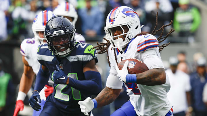 Oct 27, 2024; Seattle, Washington, USA; Buffalo Bills running back James Cook (4) rushes ahead of Seattle Seahawks cornerback Devon Witherspoon (21) during the first quarter at Lumen Field.