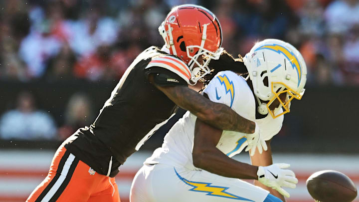 Nov 3, 2024; Cleveland, Ohio, USA; Cleveland Browns cornerback Greg Newsome II (0) knocks the ball away from Los Angeles Chargers wide receiver Quentin Johnston (1) during the second half at Huntington Bank Field. Mandatory Credit: Ken Blaze-Imagn Images