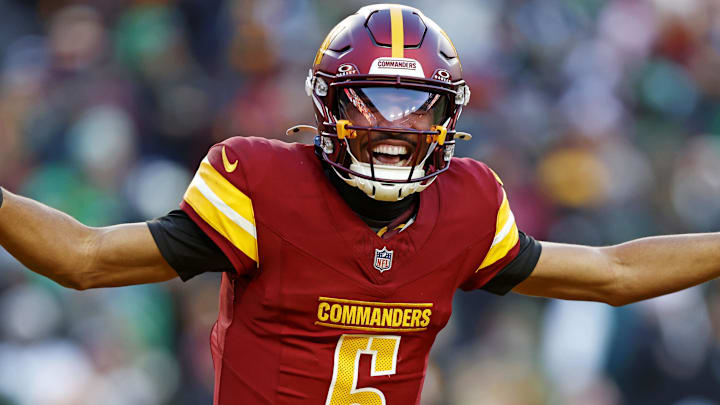 Dec 22, 2024; Landover, Maryland, USA; Washington Commanders quarterback Jayden Daniels (5) celebrates after throwing a touchdown during the fourth quarter against the Philadelphia Eagles at Northwest Stadium. Mandatory Credit: Peter Casey-Imagn Images