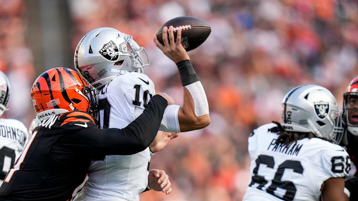 Cincinnati Bengals defensive end Trey Hendrickson (91) sacks Las Vegas Raiders quarterback Desmond Ridder (10) in the third quarter of the NFL Week 9 game between the Cincinnati Bengals and the Las Vegas Raiders at Paycor Stadium in downtown Cincinnati on Sunday, Nov. 3, 2024. The Bengals collected their first win at home with a 41-24 victory over the Raiders. Cincinnati Bengals defensive end Trey Hendrickson (91) sacks Las Vegas Raiders quarterback Desmond Ridder (10) in the third quarter of the NFL Week 9 game between the Cincinnati Bengals and the Las Vegas Raiders at Paycor Stadium in downtown Cincinnati on Sunday, Nov. 3, 2024. The Bengals collected their first win at home with a 41-24 victory over the Raiders.