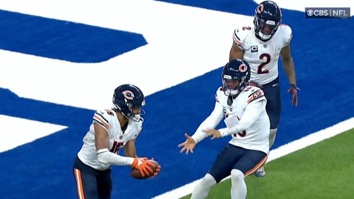 Chicago Bears receiver Rome Odunze and quarterback Caleb Williams chase each other after a touchdown ball.