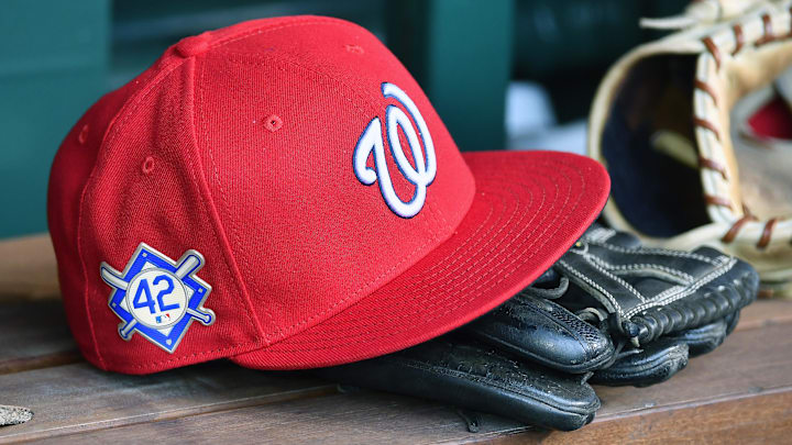 Red Washington Nationals hat on top of a black mitt
