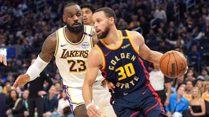 Jan 25, 2025; San Francisco, California, USA; Golden State Warriors guard Stephen Curry (30) dribbles against Los Angeles Lakers forward LeBron James (23) during the third quarter at Chase Center. Mandatory Credit: Darren Yamashita-Imagn Images