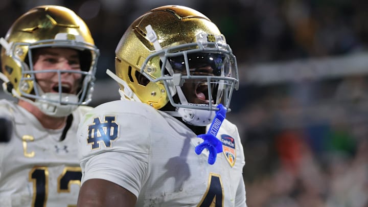 Jan 9, 2025; Miami, FL, USA; Notre Dame Fighting Irish running back Jeremiyah Love (4) celebrates a touch down in the second half against the Penn State Nittany Lions in the Orange Bowl at Hard Rock Stadium. 