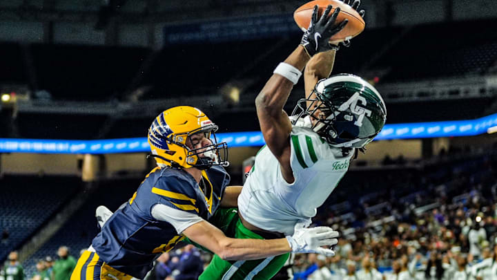 Detroit Cass Tech WR Corey Sadler Jr. catches a touchdown pass, while being covered by Hudsonville Ty Ykema in the second quarter, during the MHSAA Division 1 football finals at Ford Field in Detroit on Saturday, Nov. 30, 2024.